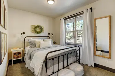 a bedroom with a bed and a window at Silver Lining Circle home in Fraser