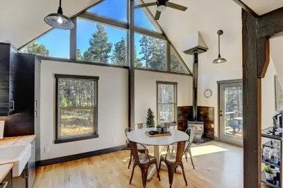 a kitchen and dining room with a table and chairs at Silver Lining Circle home in Fraser