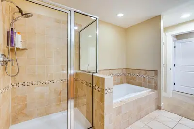 a bathroom with a shower and a bath tub at Walk to Slopes Granby Condo with Balcony! in Granby