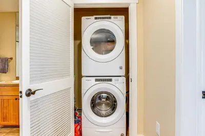 a laundry room with a washer and dryer at Walk to Slopes Granby Condo with Balcony! in Granby