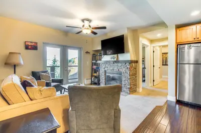 a living room with a couch and a fireplace at Walk to Slopes Granby Condo with Balcony! in Granby