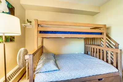 a bunk bed in a room with a lamp at Walk to Slopes Granby Condo with Balcony! in Granby