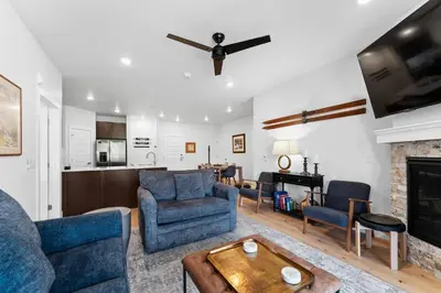 a living room with blue furniture and a fireplace at Clearwater Lofts 302 Building 1 in Keystone