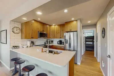 a kitchen with wooden cabinets and a counter top at Crisp Mountain Retreat in Winter Park