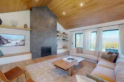 a living room with a couch and a fireplace at Valley View Retreat | Main House in Tabernash