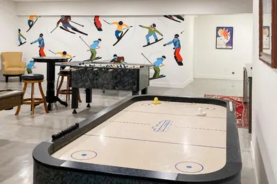 a ping pong table in a living room with a wall at Valley View Retreat | Main House in Tabernash
