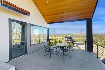 a patio with a table and chairs on a balcony at Valley View Retreat | Main House in Tabernash