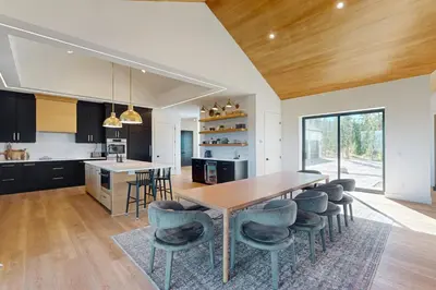a kitchen with a wooden table and chairs at Valley View Retreat | Main House in Tabernash