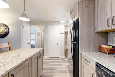 a kitchen with wooden cabinets and a black refrigerator at Summit Serenity in Dillon