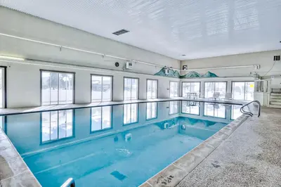 a large swimming pool in a building with windows at Summit Serenity in Dillon