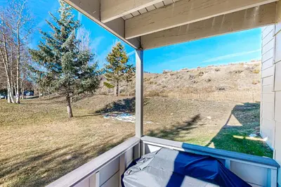 a window on a porch with a view of a field at Summit Serenity in Dillon