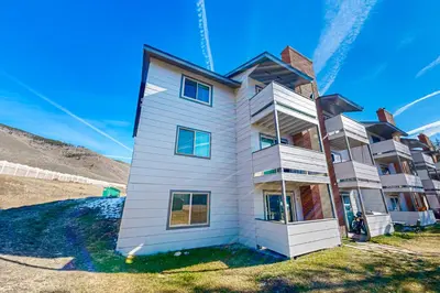 a white house on the side of a hill at Summit Serenity in Dillon