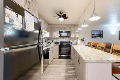 a kitchen with a refrigerator and a counter top at Summit Serenity in Dillon