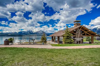 a pavilion with a picnic table and a lake at Summit Serenity in Dillon