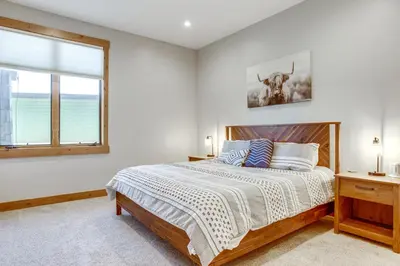a bedroom with a bed and a window at Modern Condo with Hot Tub 5 Mi to Winter Park! in Fraser
