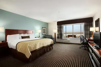 a hotel room with a bed and a television at Baymont by Wyndham Denver International Airport in Denver