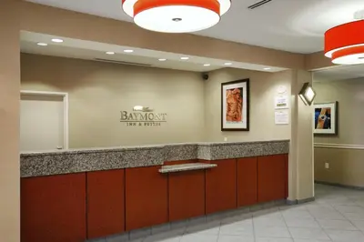a lobby with a barrett risk hotel sign on the wall at Baymont by Wyndham Denver International Airport in Denver