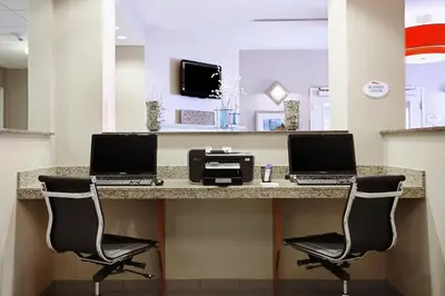 two laptops sitting on a counter in a hospital room at Baymont by Wyndham Denver International Airport in Denver