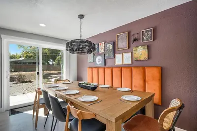 a dining room with a wooden table and chairs at Colorful Getaway Hot Tub Enchanting Yard in Denver