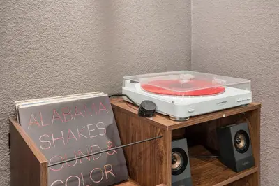 a toaster on a stand with a sign and a chalkboard at Colorful Getaway Hot Tub Enchanting Yard in Denver