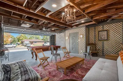 a living room with a pool table and chairs at Colorful Getaway Hot Tub Enchanting Yard in Denver