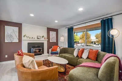 a living room with a couch and chairs and a fireplace at Colorful Getaway Hot Tub Enchanting Yard in Denver