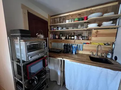 a kitchen with a counter with a microwave and a sink at Large Studio LIGHT & VIEWS - Beautiful with Deck - Message Direct in Idaho Springs