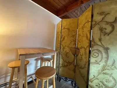 a small room with a table and two stools at Large Studio LIGHT & VIEWS - Beautiful with Deck - Message Direct in Idaho Springs