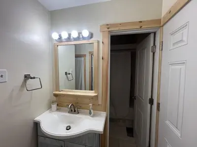 a bathroom with a sink and a mirror at Large Studio LIGHT & VIEWS - Beautiful with Deck - Message Direct in Idaho Springs