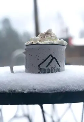 a cup of coffee sitting on top of a table at Flying Dutchman 1110 by SummitCove Lodging in Keystone