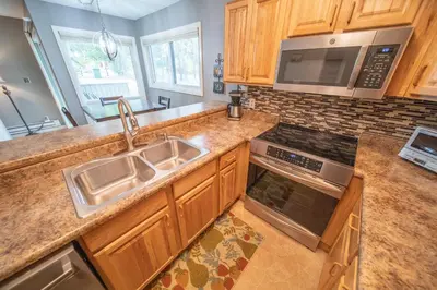 a kitchen with a sink and a microwave at Flying Dutchman 1110 by SummitCove Lodging in Keystone