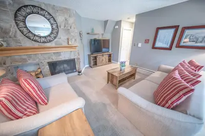 a living room with two couches and a fireplace at Flying Dutchman 1110 by SummitCove Lodging in Keystone