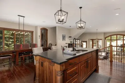 an open kitchen and dining room with a large island at Iron Horse Manor home in Winter Park