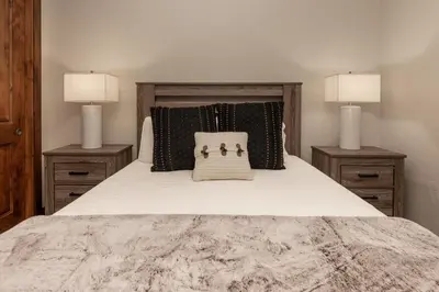 a bedroom with a large bed with two night stands at Iron Horse Manor home in Winter Park