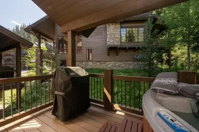 a porch with a bed on a deck at Iron Horse Manor home in Winter Park