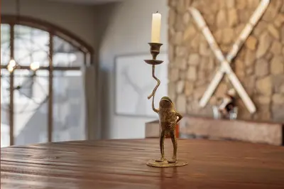 a small bronze figurine next to a candle on a table at Iron Horse Manor home in Winter Park