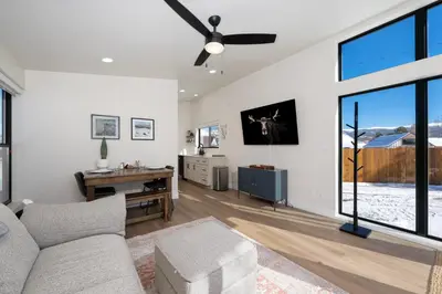 a living room with a couch and a ceiling fan at Luxury Modern Tiny Home in Downtown Fraser in Fraser