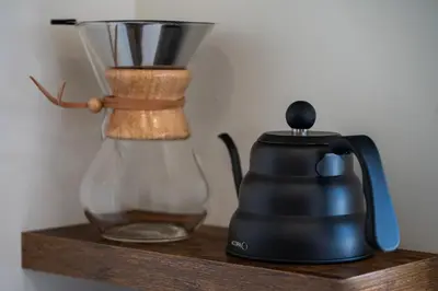 a black blender sitting on a wooden shelf at Luxury Modern Tiny Home in Downtown Fraser in Fraser