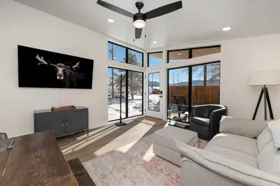 a living room with a cow on the wall at Luxury Modern Tiny Home in Downtown Fraser in Fraser