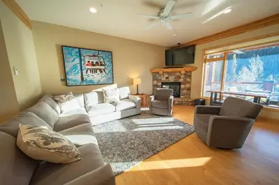 a living room with a couch and a fireplace at Mill Creek 201 by SummitCove Lodging in Keystone