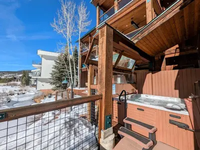 a balcony of a house with a kitchen and a view at Mill Creek 201 by SummitCove Lodging in Keystone