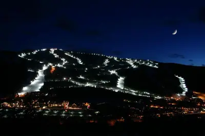 a night view of a mountain with lights on it at Ironwood 2996 by SummitCove Lodging in Keystone