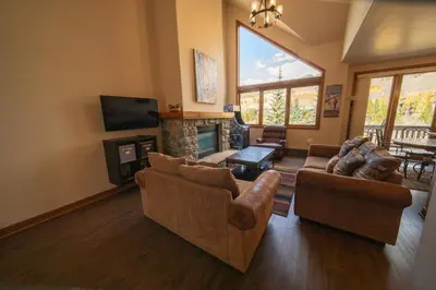 a living room with two couches and a fireplace at Ironwood 2996 by SummitCove Lodging in Keystone