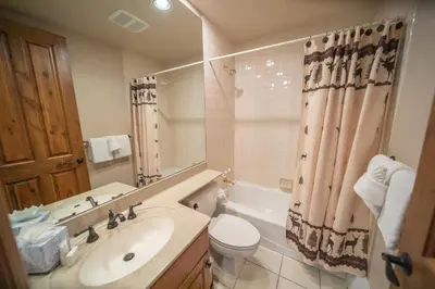 a bathroom with a sink and a toilet and a tub at Ironwood 2996 by SummitCove Lodging in Keystone