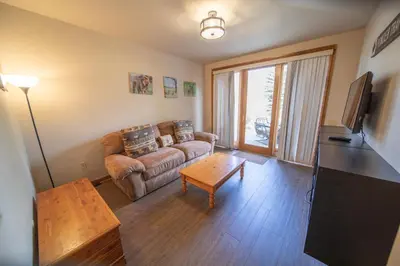 a living room with a couch and a table at Ironwood 2996 by SummitCove Lodging in Keystone