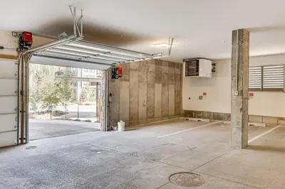 an empty parking lot with an open garage door at Mountain-View Condo in Downtown Winter Park! in Winter Park
