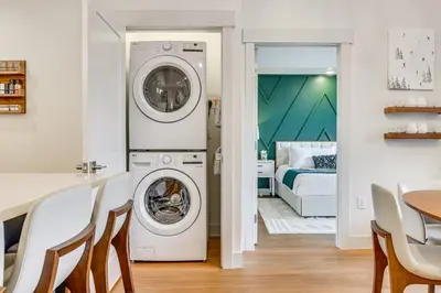 a kitchen and dining room with a washer and dryer at Mountain-View Condo in Downtown Winter Park! in Winter Park
