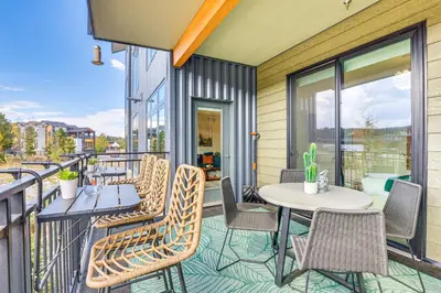 a patio with tables and chairs on a balcony at Mountain-View Condo in Downtown Winter Park! in Winter Park