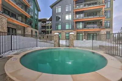 an empty swimming pool in front of some buildings at Mountain-View Condo in Downtown Winter Park! in Winter Park