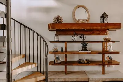 a stairwell with wooden shelves and a spiral staircase at Alpine Hideaway with Free Shuttle - Wildernest in Silverthorne